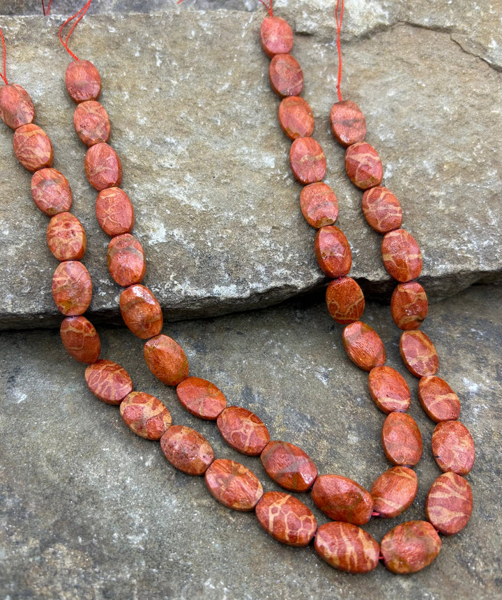 Apple Coral Faceted Oval Beads 12x20mm 16 inch strand